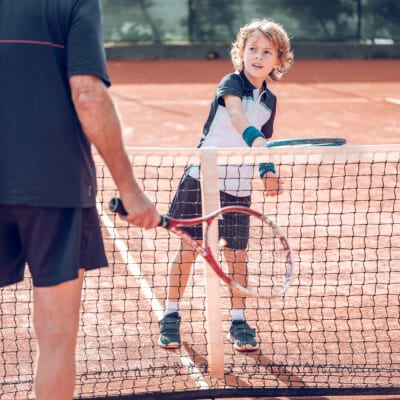 active-little-boy-practicing-tennis-with-crop-male-2022-02-03-23-30-10-utc.jpg